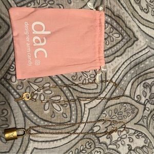 Authentic Louis Vuitton lock and key on a necklace.